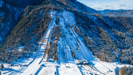 Planica Nordic Centre, nestled in the breathtaking Julian Alps of Slovenia, is a world-renowned destination for ski jumping and winter sports captured from a drone