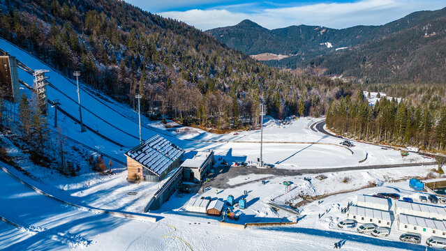 Planica Nordic Centre, nestled in the breathtaking Julian Alps of Slovenia, is a world-renowned destination for ski jumping and winter sports captured from a drone