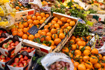 London, UK – December 3, 2024, Mandarins in crates, strawberries, and grapes at Borough Market.