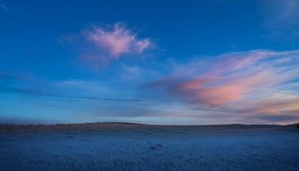 A scene of colorful clouds magically flowing over a blue sky, emitting colorful light.