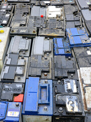 Stack of many used car batteries for recycling in a hazardous waste facility