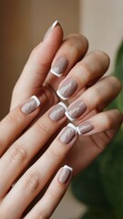 A close-up shot of a girl&acute;s hand with a neat manicure. The nails are in Mocha Mousse. 