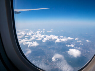 The porthole of the plane. The flight of the plane, the view from the window. A wing, blue sky and...