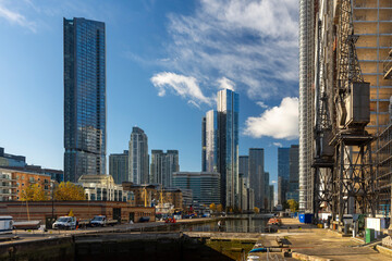 Naklejka premium London, UK - December 4, 2024, view of Canary Wharf and South Quay Plaza in good weather from the docks