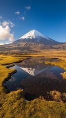 Fototapeta premium Scenic view of a snow-capped mountain reflected in a tranquil pond.