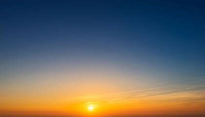 Obraz premium clear sky background during sunrise with warm orange and yellow hues