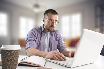 Happy handsome entrepreneur man work on laptop at office