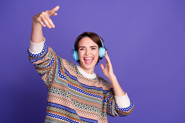 Photo of cheerful crazy positive woman wear stylish clothes listen music isolated on purple color...