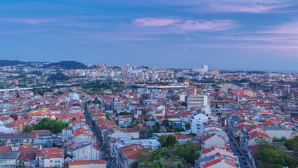 Rooftops of Porto's old town on a warm spring evening timelapse day to night, Porto, Portugal