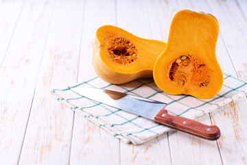 two halves of butternut squash  on a white table, selective focus.