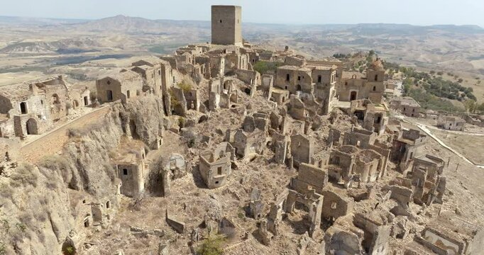 Aerial view of the church located in Craco, a ghost town in the province of Matera, Basilicata, Italy. The historic center was depopulated due to a landslide and has become a tourist destination.