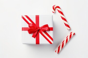 Christmas Gift Box with Red Ribbon and Candy Canes on White Background for Celebratory Occasions and Seasonal Cheerful Decorations