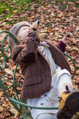 little girl posing in an autumn environment with brown leaves