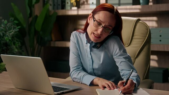 Busy multitasking girl business woman planner managing business tasks write notes stressed irritated entrepreneur businesswoman talk mobile phone call consult work online laptop stress deadline office