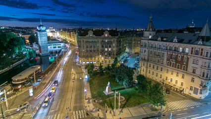 Sitkovska water-tower night timelapse and traffic on road in old city center of Prague.