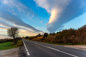 Golden clouds at sunset over the mountain road of the Sierra de Guadarrama, Madrid.