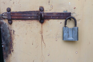 A Rusty Lock and Latch Attached to a Vintage Door, Highlighting Interesting Details and Design