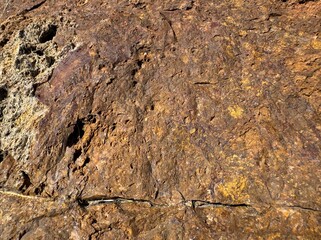 Background texture of brown stone wall. Surface stone zinc, copper mine close-up background pattern. Stone hematite, jecheon, chungbuk surface. Granite stone texture. Natural mountain stone. 
