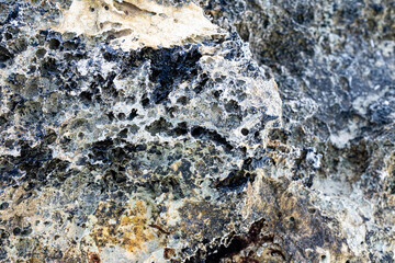 Rocks in the shore of a beautiful white sand beach with turquoise waters in Mediterranean Sea in Puglia, South Italy