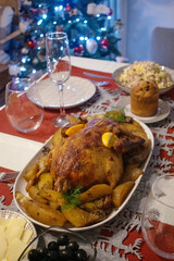 A cozy Christmas table is set with various dishes, including roasted duck and fresh salads