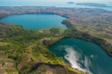 Aerial view from Mont Passot over the crater lake Lac Amparihibe and the Indian Ocean, Nosy Be, Madagascar.