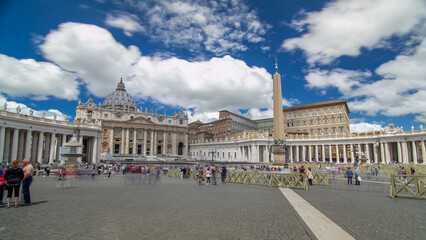 Fototapeta premium St. Peter's Square full of tourists with St. Peter's Basilica and the Egyptian obelisk within the Vatican City timelapse hyperlapse