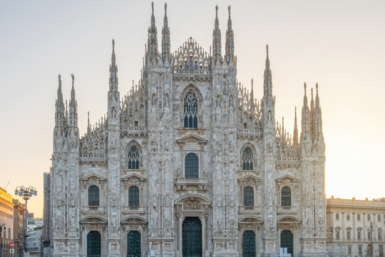 Milan Cathedral on Cathedral square in the morning, Milan, Lombardia, Italy. Piazza del Duomo with Duomo di Milano with intricate Gothic architecture - Powered by Adobe