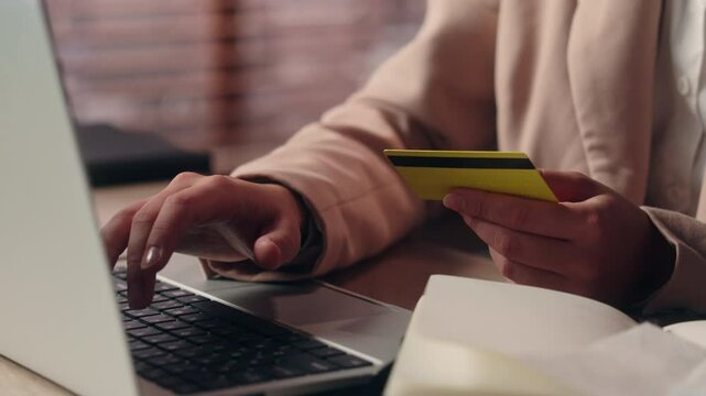 Close up unknown confused Caucasian business woman girl female businesswoman lady customer client try pay online holding credit card enter password laptop error mistake scam bank fail payment indoors