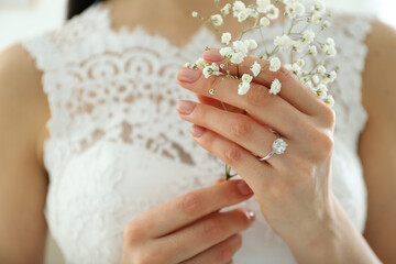 Young bride wearing beautiful engagement ring, closeup