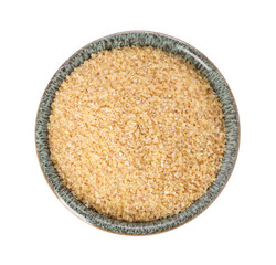Raw wheat groats in bowl isolated on white, top view