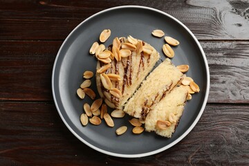 Delicious sweet semolina halva with peanuts on wooden table, top view