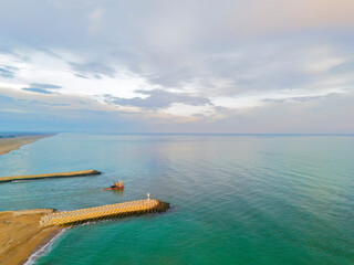 Fototapeta premium defauTurkiye Sakarya Karasu Adapazari Aerial view of a tranquil coastal harbor with breakwaters and a small vessel.High-angle, full shot of a serene coastal harbor, showcasing a calm turquoise sea met