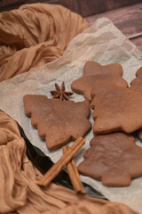 Christmas homemade baking, close-up gingerbread cookies with spices, cloth on a background