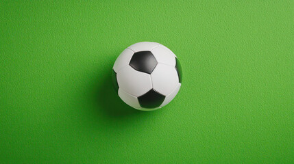 Obraz premium close up of soccer ball on vibrant green background, showcasing its classic black and white pattern