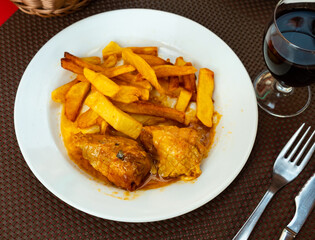 Stuffed chicken, cooked in food grid, served for dinner with baked potatoes. Dish is accompanied by appetizer - pickled olives.