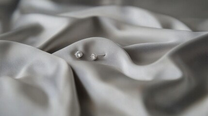 Obraz premium Elegant Diamond Earrings on Soft Silky Fabric Background