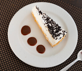 Piece of banoffee pie english dessert with topping served on plate