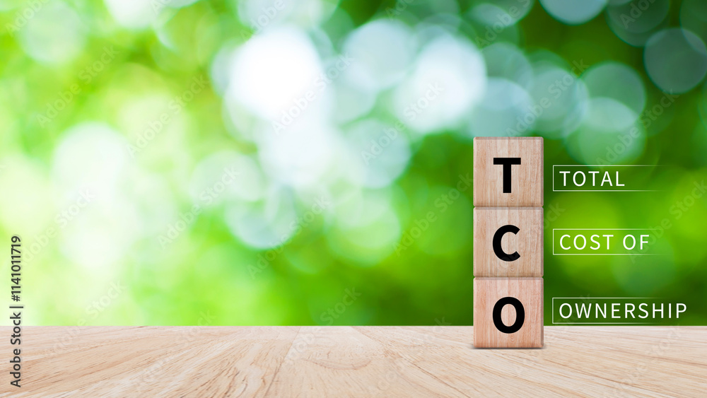 Aufkleber tco concept. total cost of ownership text on a wooden block, purchase price of an asset plus the cos