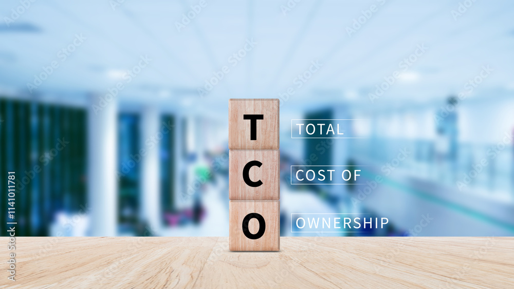 Aufkleber tco concept. total cost of ownership text on a wooden block, purchase price of an asset plus the cos
