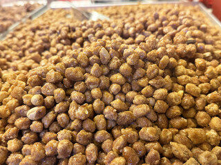 Close-up of caramelized peanuts in pile at food market