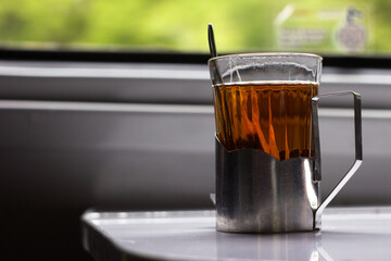 A glass of tea in a metal cup holder in a Ukrainian train carriage