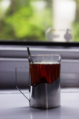 A glass of tea in a metal cup holder in a Ukrainian train carriage