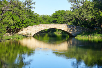 Fototapeta premium Stone bridge over a tranquil river
