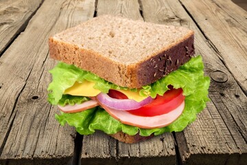 Tasty fresh sandwich with vegetables on the desk