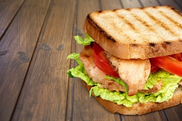 Tasty fresh sandwich with vegetables on the desk