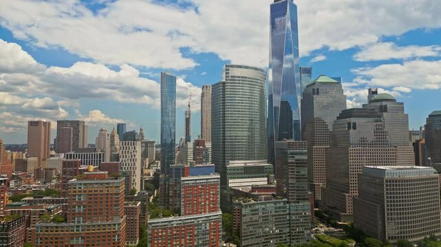 Manhattan and One World Trade Center in New York City, USA as seen from Weehawken New Jersey. Skyscrapers of Manhattan located near rippling water of New York bay against blue sky. NYC, USA.