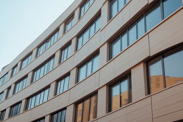 Modern architectural design showcasing a curved building facade with multiple windows in an urban setting