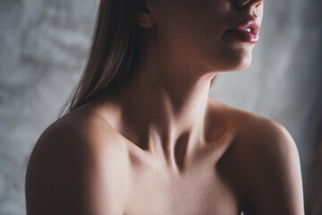 Elegant young woman with blond hair posing in sensual studio setting