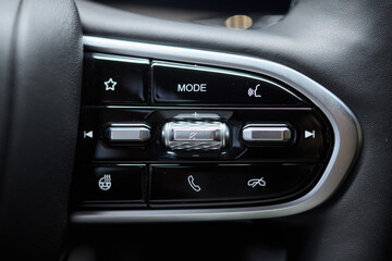 Fototapeta premium The modern cars steering wheel control panel boosts convenience and performance