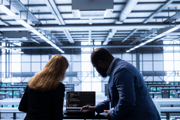 Computer scientists in data center tracking network traffic and activity, installing and...